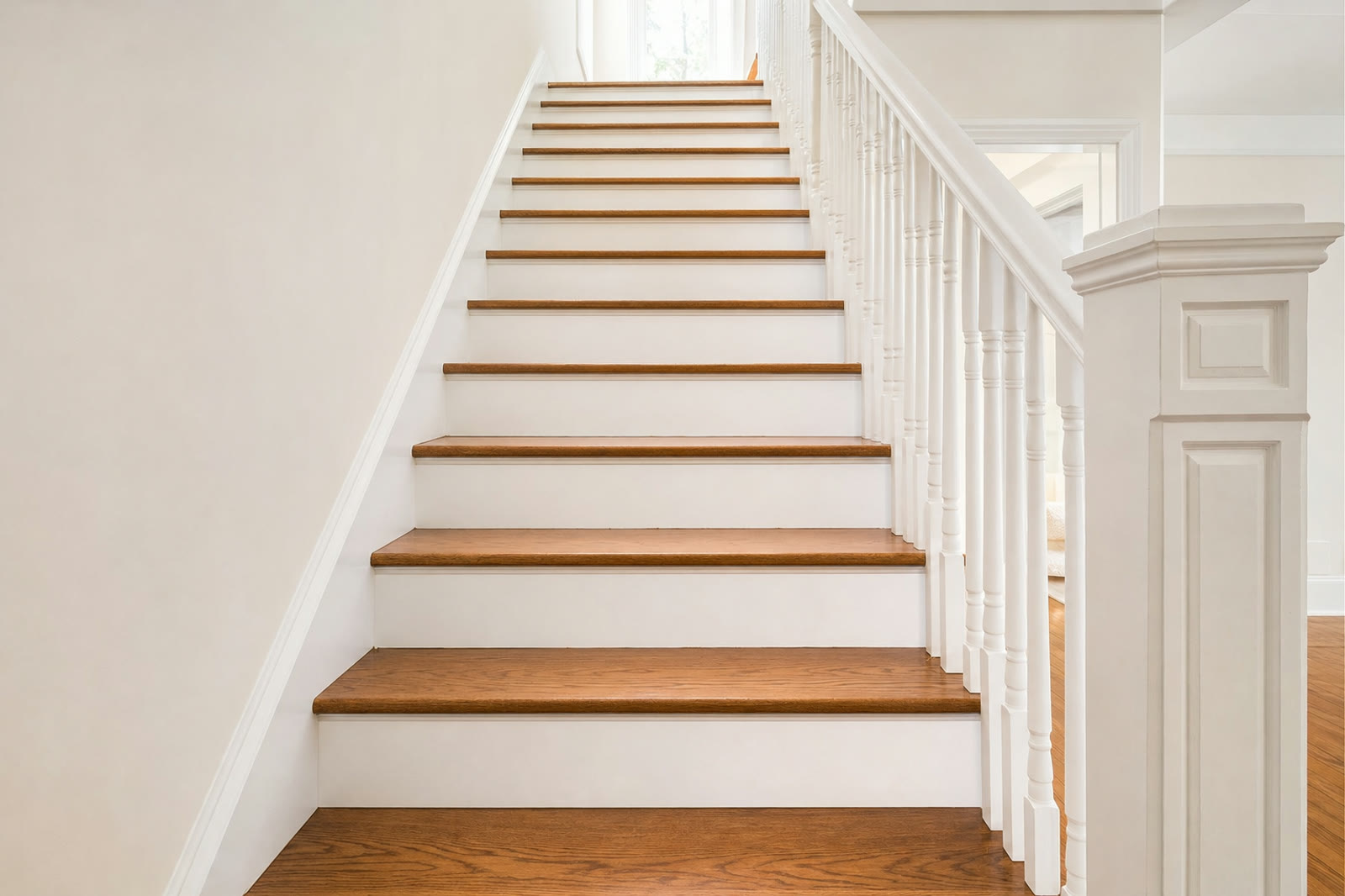 A staircase with refinished oak treads and white risers